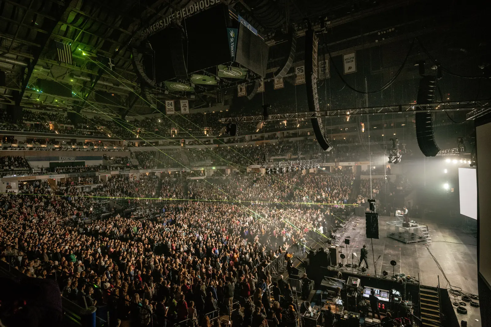 Wide view of an arena concert with hung line arrays