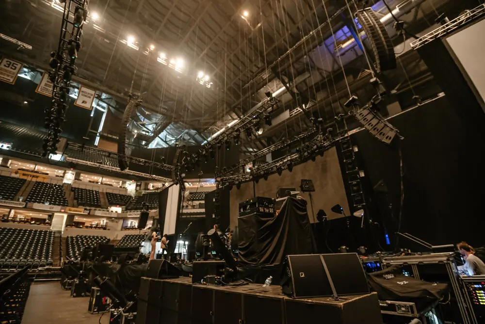 Arena floor during load-in with rigging and line arrays