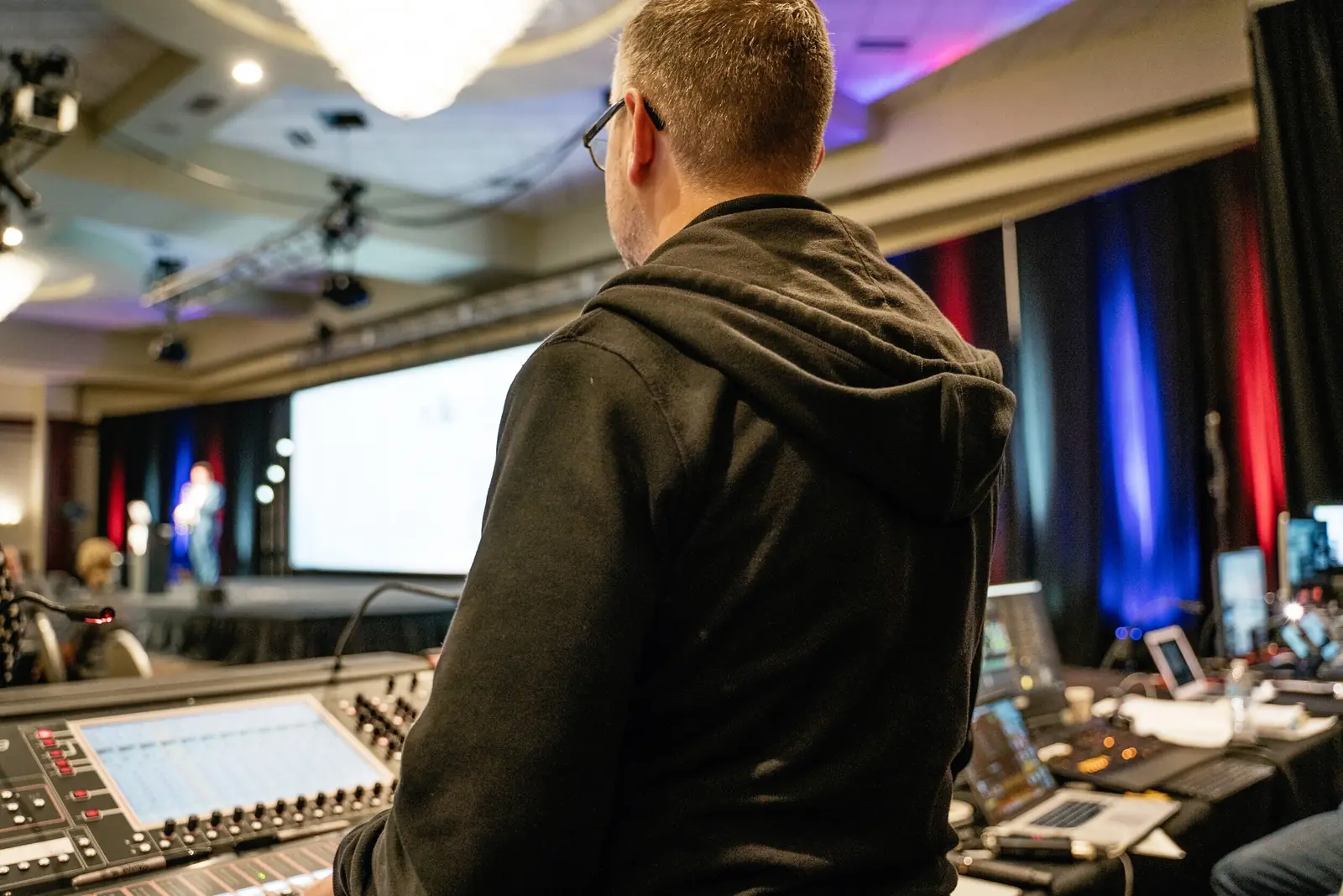 Engineer mixing a ballroom general session from front of house