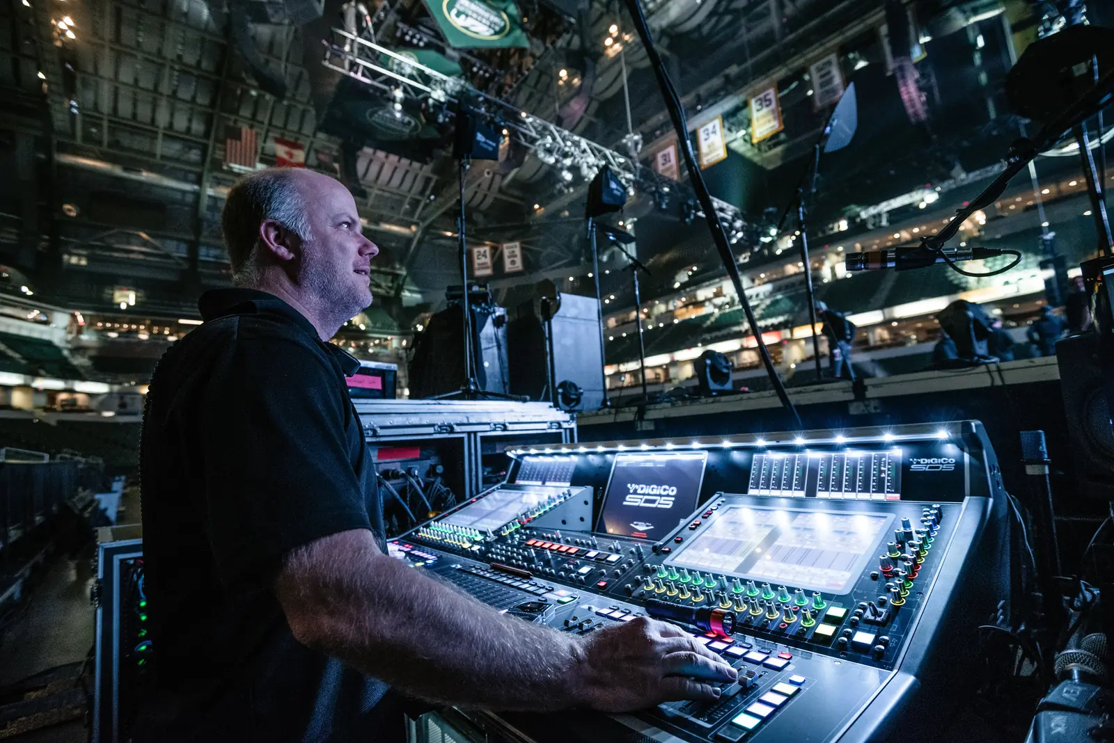 Front-of-house engineer mixing on a DiGiCo console in an arena